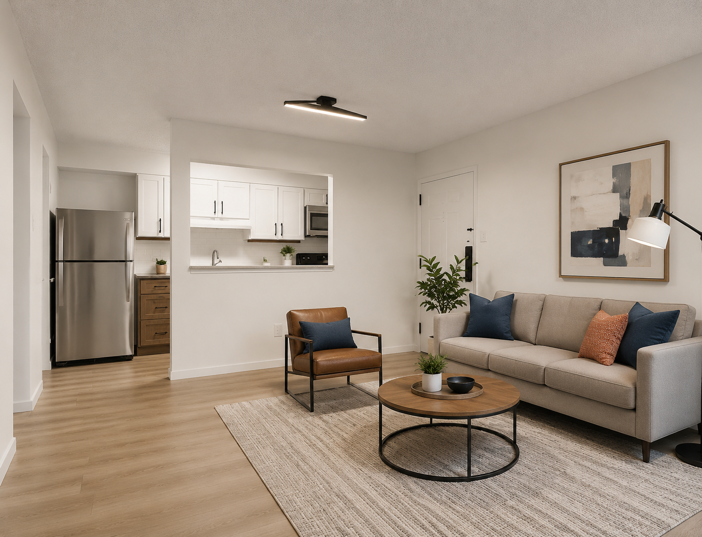 Rendering of a renovated one-bedroom apartment interior at Oak Hollow — open living room with plank flooring and white kitchen