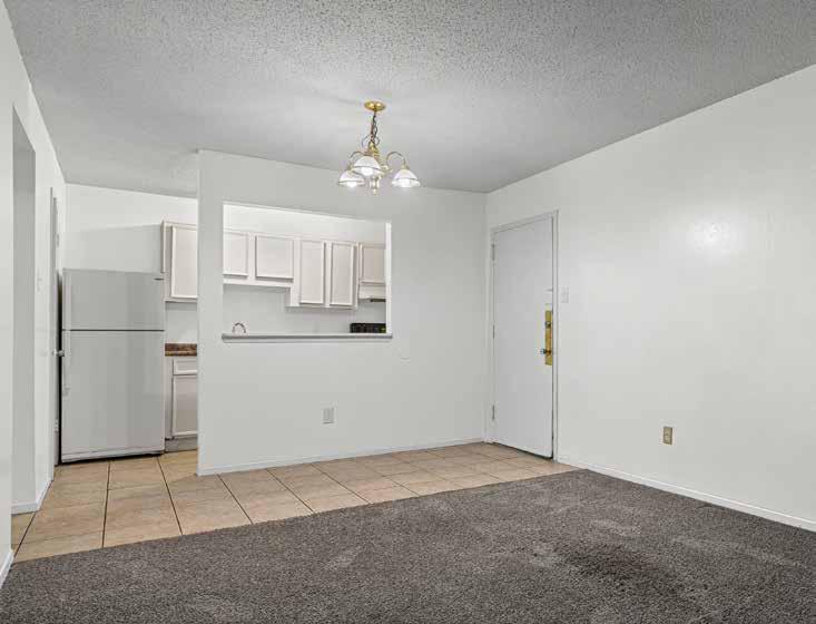 Dining area and kitchen pass-through in a one-bedroom apartment at Oak Hollow