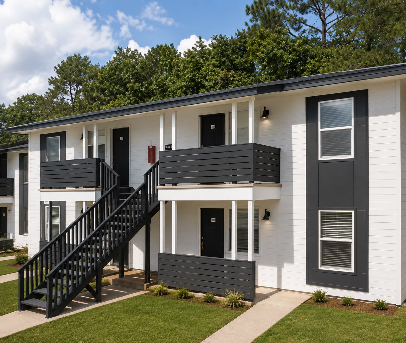 Apartment building entries with private balconies at Oak Hollow